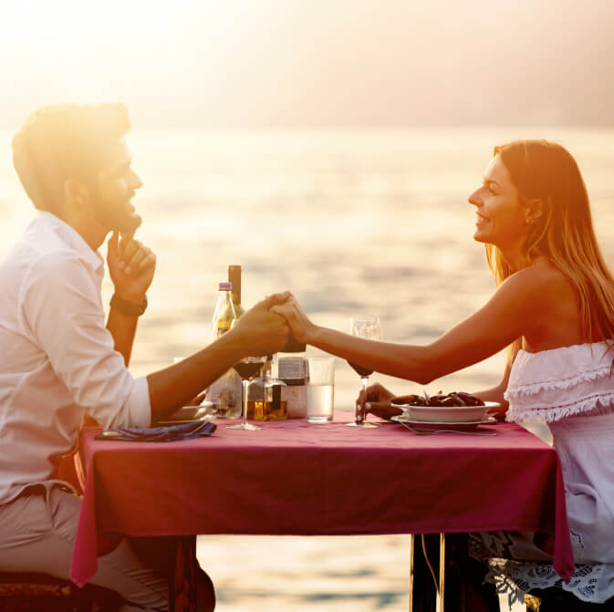 Romantic date of a couple with food and wine on the table